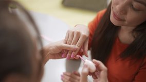 4K Millennial Asian woman friends sitting on the floor in living room and applying nail polish together. Female friendship enjoy weekend activity lifestyle with beauty treatment and make up at home - Powered by Shutterstock - Get 15% off with code: PIKWIZARD15