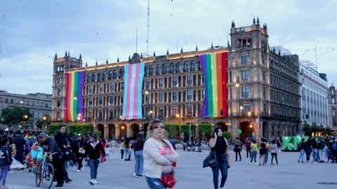 Mexico City, Mexico- June 2021: Timelapse of buildings in the zocalo of Mexico City during the lgbt pride march, in the buildings you can see the trans and lgbt flags.