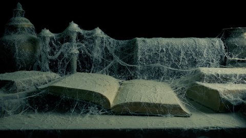 Open Book Covered In Cobwebs And Dust Moving Shot
