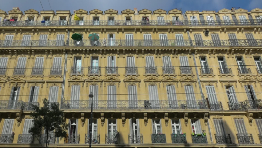 Facade of classic french apartment building with traditional Haussmann architecture, Marseille, France