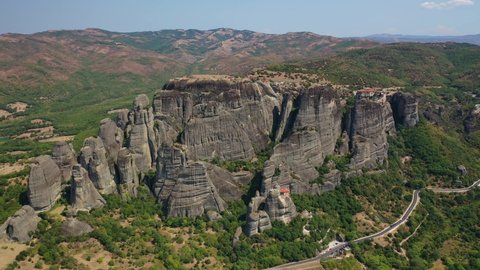 Aerial drone video of iconic Meteora rock formation complex of immense natural pillars and hill-like rounded stones, an Unesco World Heritage site, Thessaly, Greece