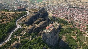 Aerial drone video of Monastery of St. Charalambos at Meteora monasteries complex of immense natural pillars and hill-like rounded rocks, an Unesco World Heritage site, Thessaly, Greece