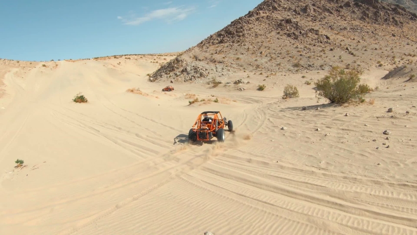 Orange Dune Buggy Driving in the Desert Sand Dunes	 Royalty-Free Stock Footage #1079934521