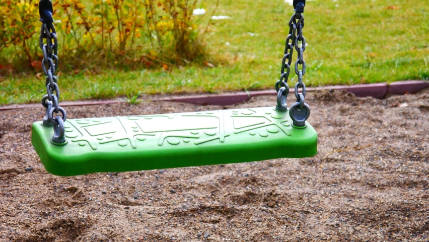 Close-up of a green swing with chains swaying back and forth Royalty-Free Stock Footage #1079934803