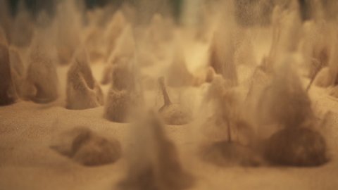 Science and physics experiments with quicksand volcanos. Hypnotic fluid sand exploding by injecting air