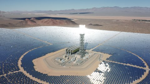 Breathtaking aerial panorama view around solar towers reflecting sun rays on solar panels. Desert heliostat on sunny day. Aerial 4K Ivanpah Solar Electric Generating System in Nipton California Nevada