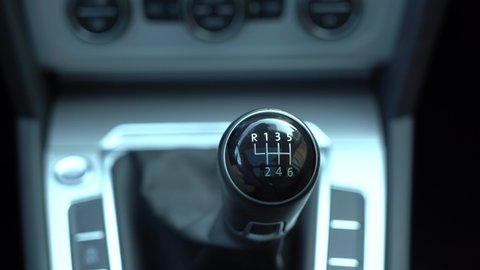 Man driver changing gears with manual transmission gear stick, close up