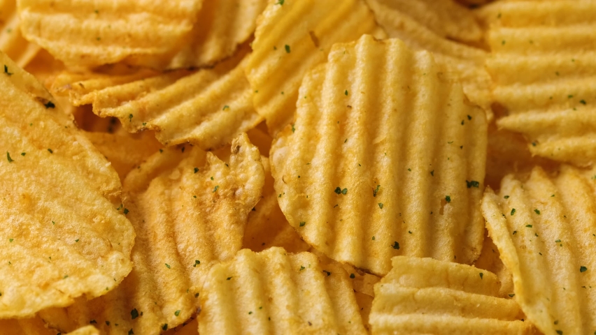 Potato chips with cheese and herbs. Rotating video