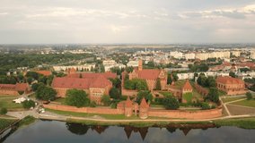 Malbork,Poland.Aerial 4K video from drone to Medieval Malbork ( Zamek w Maborku, Ordensburg Marienburg ),castle in Poland fortress of the Teutonic Knights at the Nogat river in sunset light.(Series)