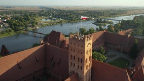 Malbork,Poland.Aerial 4K video from drone to Medieval Malbork ( Zamek w Maborku, Ordensburg Marienburg ),castle in Poland fortress of the Teutonic Knights at the Nogat river in sunrise light.(Series)