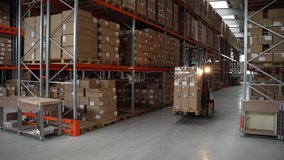 Professional forklift driver moving huge pallet of cardboard boxes while riding between rows of racks in storehouse. Male worker in hard hat driving loader with goods around warehouse - Powered by Shutterstock - Get 15% off with code: PIKWIZARD15