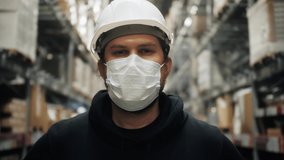 Portrait of a frontline worker in a warehouse. Manager of warehouse standing next to manufactured storehouse stock or hardware store racks. Close-up portrait. Concept of transportation and logistics. - Powered by Shutterstock - Get 15% off with code: PIKWIZARD15
