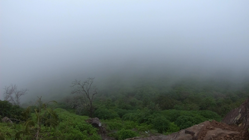 4K Time-lapse of the fog in the forest at Saputara, Gujarat, India. View of the fog as seen from Sunset point at Saputara in Gujarat, India. Clouds covering the green hills during the monsoon.
