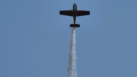 Maribor Airshow Slovenia AUGUST, 15, 2021 Propeller aircraft in the blue sky with white smoke. MX Aircraft MXS by Veres Zoltan
