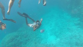 Snorkeling man with an action camera dive in the sea and shoots a video camera