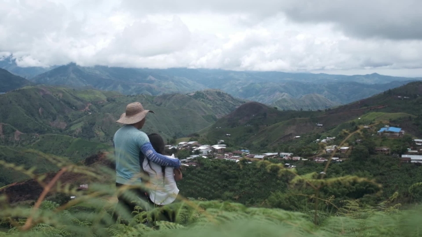 Farmer and daughter look into the mountains as daughter hugs dad in el Cauca, Colombia Royalty-Free Stock Footage #1079976260