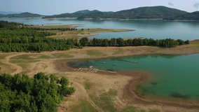 Aerial drone video of beautiful artificial lake of Plastiras or Tavropos with wonderful nature and famous outdoor and water activities like canoe and water bike, Thessaly, Greece 