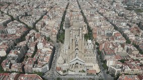 Aerial view of La Sagrada familia cathedral, over the city of Barcelona, in Spain. Drone video of Sagrada Familia neighbourhood in Catalonia, Peninsula Iberica Espana.
