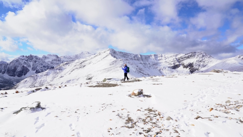 A hiker stands on top of Whisters Mountain in Jasper National Park 4k.