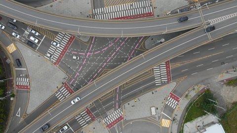 Cars drive along road junction in South Korea top view.