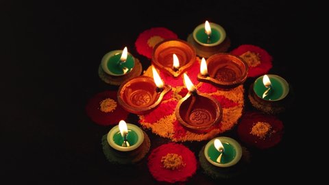 Diwali celebration in Indian also called festival of lights. Lighted oil lamp or Diya. Deepavali Hindu festival of North India, Mumbai Delhi India. Om written in Hindi inside Diya.