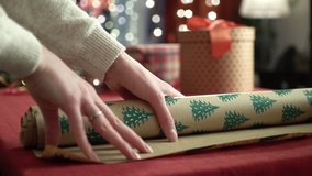 Young woman packing Christmas gifts for her friends and relatives, Close up of female hands packing Christmas gifts for friends. Christmas decorations, preparing for the festive season. - Powered by Shutterstock - Get 15% off with code: PIKWIZARD15