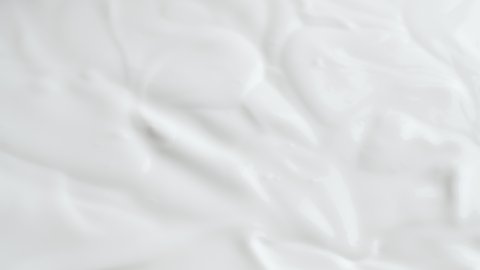 Shooting of sliding background with spoon in white cream