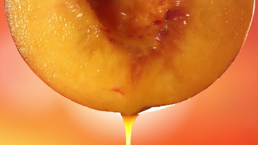 Slow Motion Macro Shot of Flowing Peach Juice from Half Peach | Shutterstock HD Video #1080008171
