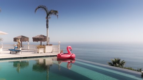 Floating hot pink Flamingo mattress. Perfect Summer vacation travel background. Copy space on bright blue sky background. Pink flamingo in blue infinity pool in luxury hotel resort with ocean view