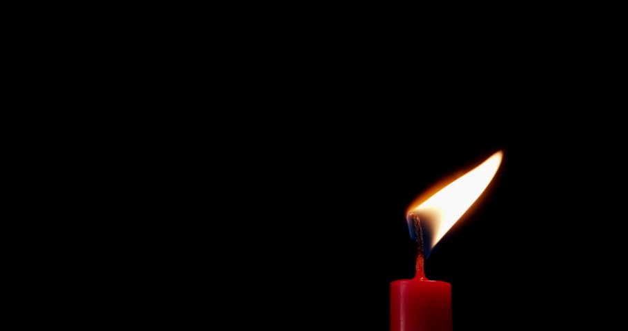 Candle on a black background. The flame of the candle slowly flickers. One candle slowly flickers. Ideal for background or over-layer with blending mode add, screen, lighten.