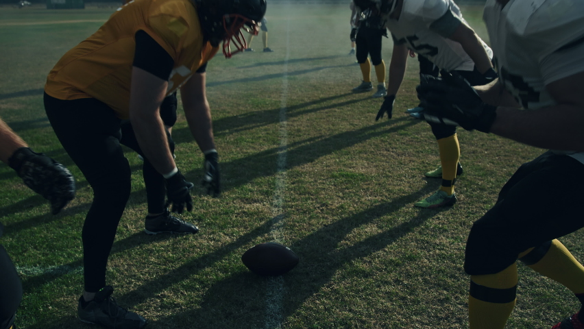 American Football Field: Two Professional Teams Clash, Attacking to Score Touchdown Points. Athletes Brutally Compete for the Ball, Tackle Each other. Dramatic Slow Motion with Immersive Cinematic Royalty-Free Stock Footage #1080022169