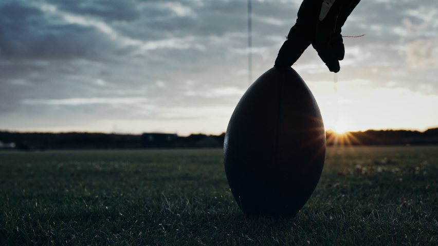 Cinematic American Football Kickoff Game Start. Static Close-up of Ball Being Kicked by the Professional Player. Gates Goal Kick. Successful Team Scores and Wins Championship. Stylish Slow Motion Shot Royalty-Free Stock Footage #1080022244
