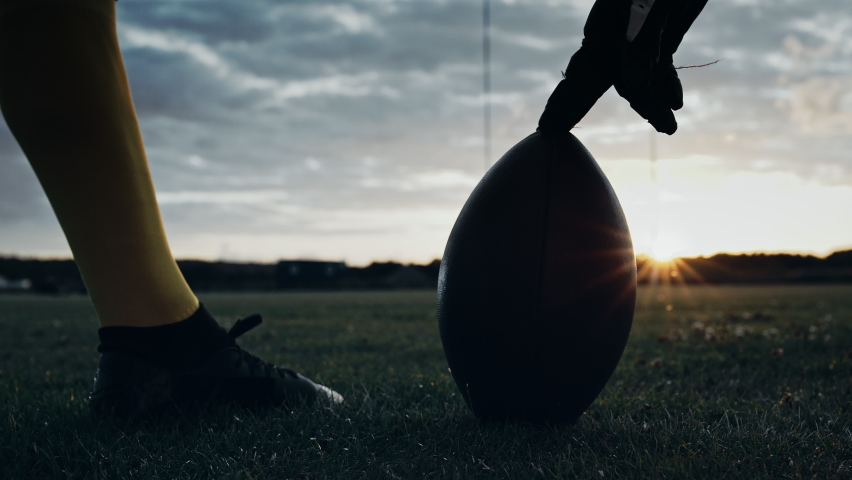Cinematic American Football Kickoff Game Start. Static Close-up of Ball Being Kicked by the Professional Player. Gates Goal Kick. Successful Team Scores and Wins Championship. Stylish Slow Motion Shot