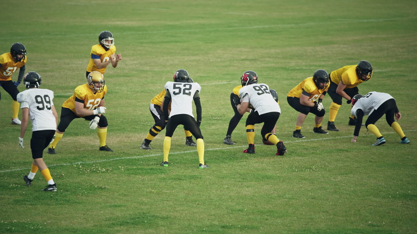 American Football Teams Start Game: Professional Players, Aggressive Face-off, Tackle, Pass, Fight for Ball and Score. Warrior Competition Full of Brutal Energy, Power, Skill. Fast Paced Wide Shot Royalty-Free Stock Footage #1080022319