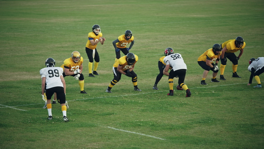 American Football Teams Start Game: Professional Players, Aggressive Face-off, Tackle, Pass, Fight for Ball and Score. Warrior Competition Full of Brutal Energy, Power, Skill. Slow Motion Wide Shot Royalty-Free Stock Footage #1080022322