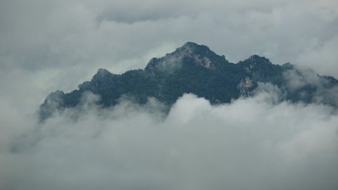 Time lapse, Beautiful Landscape in the morning time during sunrise with fog above the mountain, White fluffy clouds moving softly on cloudy, Pang puay, Mae moh, Lampang, Thailand.