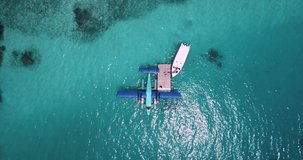 Aerial view of motorboat approaching hydroplane floating in turquoise water. High quality 4k footage