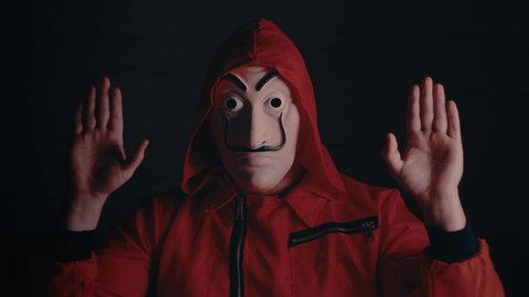 Cosplay for the TV series "La casa de papel (paper house) on Netflix. Portrait of actor in a red suit with a hood and a mask similar to the artist Dali. Moscow, Russia