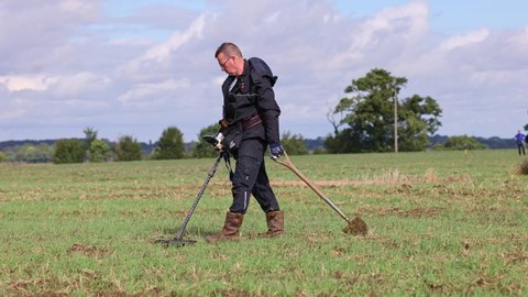 Much Hadham, Hertfordshire, UK. October 1st 2021. Treasure hunter using a metal detector in a field.  