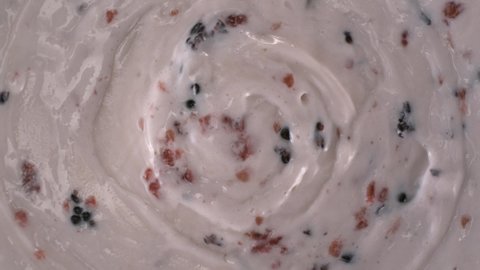 Swirling delicious looking, well crafted fresh yogurt that made with red-black raspberries and blueberry rotates in reverse clockwise.