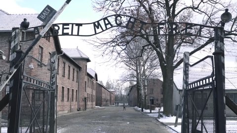 Auschwitz, Poland, January 9, 2020: Main gate of the Auschwitz concentration camp. Arbeit Macht Frei a sign seen by prisoners coming to the camp.