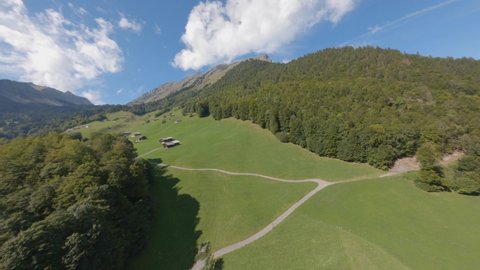FPV drone flight in the Alpine mountains. Austria. FPV drone flight. Shooting of the landscape, mountains, alpine houses. Drone shooting of the Alpine mountains.