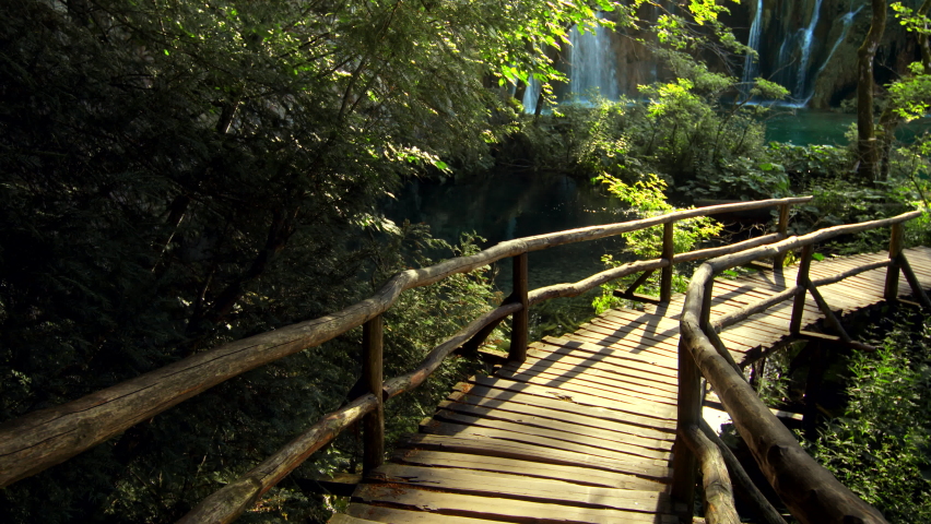 Young traveler walking near the waterfalls