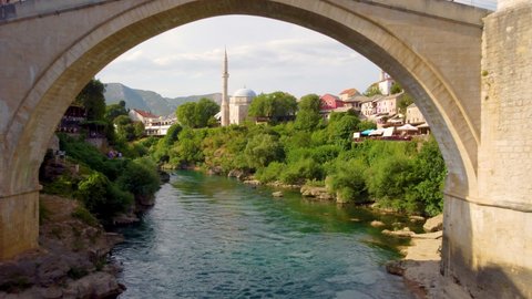 Medieval Arched Bridge Of Stari Most At The Old City Of Mostar In Bosnia and Herzegovina. Aerial Pullback