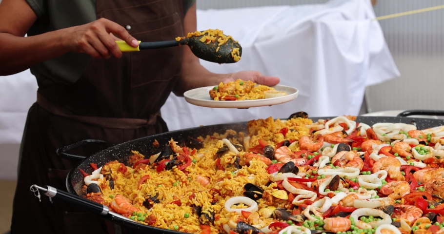 Chef Cooking Paella Rice Dish In Big Wok. HD, 1920x1080. High quality 4k footage | Shutterstock HD Video #1080074045