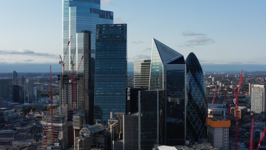 Slide and pan footage of futuristic office buildings in City. Gherkin, Scalpel and other iconic modern skyscrapers. London, UK Royalty-Free Stock Footage #1080075164