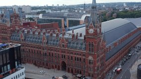 Descending aerial footage of majestic red brick historic building of St Pancras train station and hotel. London, UK