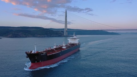 ISTANBUL - CIRCA 2021: Oil chemical tanker Astella ploughs through the water. Aerial of the 184 meters long tanker ship underway. Tracking shot of supertanker ship from nose side at morning
