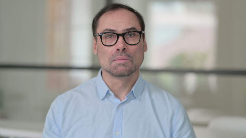 Middle Aged Man showing No Sign by Arm Gesture