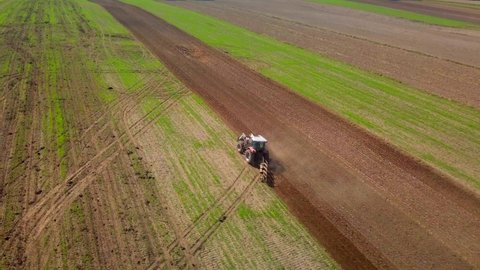 Tractor ploughing field. Polish aerial landscape with tractor.